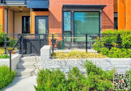 Small patio with BBQ in front of private entrance to a residential unit