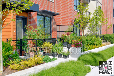 Entrance of residential unit decorated with flowers on bright sunny day