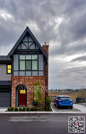 A perfect neighbourhood. Residential townhouse on later evening sky background