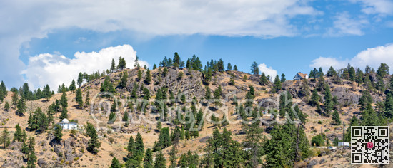 Mountain landscape with residential houses on hot summer day