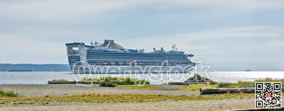 White ocean cruise liner passing by Burrard inlet in Vancouver, Canada
