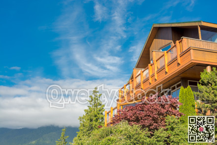 Top of wooden residential house on blue sky background
