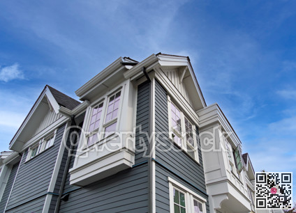 Top of residential townhouse on blue sky background