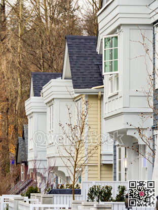Frontside of brand new residential townhouses. Row of townhouses for sale