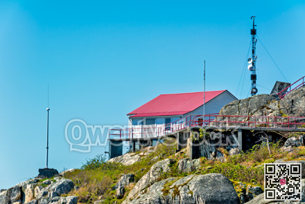 A lighthous service structure on rocky coast of Pacific ocean in Vancouver, BC