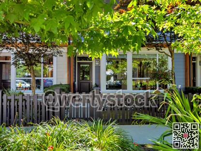 Front side of residential units with small yards and concrete walkway in front
