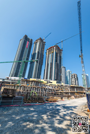 High-rise residential buildings under construction on blue sky background