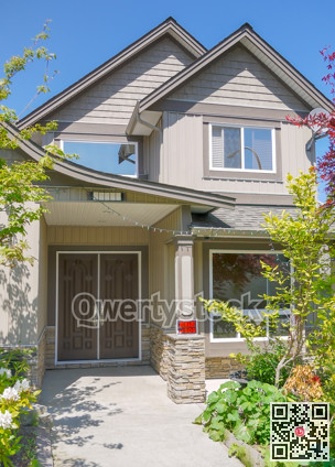 Entrance of family house with concrete pathway in front