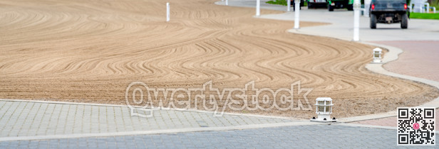 Sand on a beach enligned with leveling drag