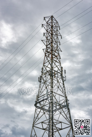High voltage electric tower on overcast sky background