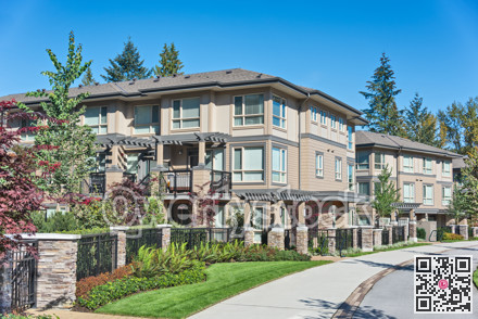Paved pathway along residential building on sunny day