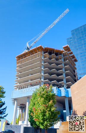 Concrete building under constraction on blue sky background