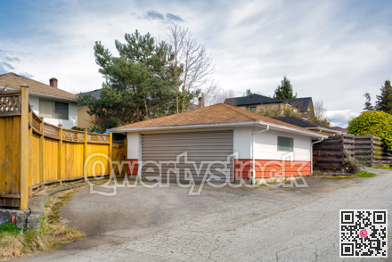 Detached garage of residential house with asphalt road in front