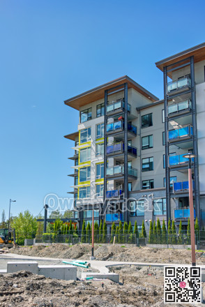 Low-rise residential building under construction on blue sky background