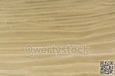 Waves of sand on one of Pacific ocean beaches