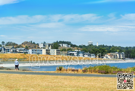 Lonely person looking at Victoria city waterfront area on Vancouver island