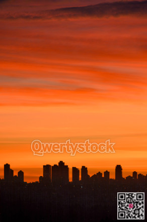 Urban silhouette of buildings on sunset sky background