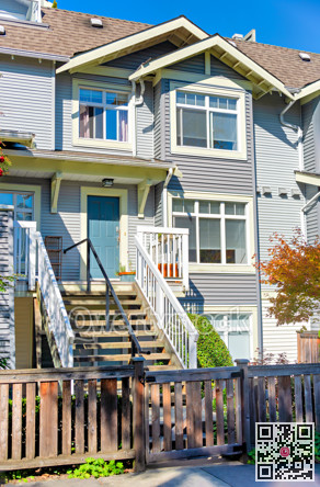 Small front yard and stairway to the entrance of residential townhouse