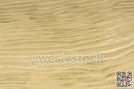 Waves of sand on one of Pacific ocean beaches