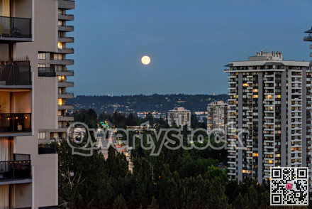 Night city view with full yellow moon raising over