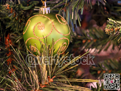 Green decorative ball on Christmas pine tree brench