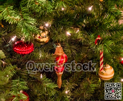 Halo of electtric lights and color balls decorating artificial Christmas tree