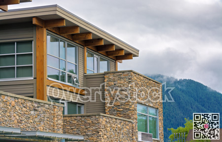 Top of nice residential building on foggy mountain background