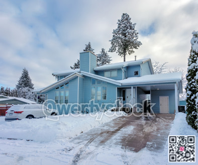 Duplex residential house in snow on overcast winter day