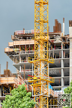 Construction of concrete high rise residential building with the crane in front