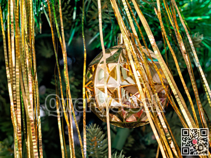 Golden ball and threads decorations on Christmas tree