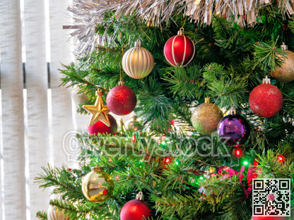 Red, golden, purple balls and color electtric lights decorating Christmas tree