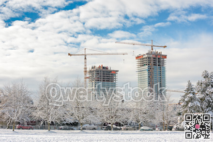 New high-rise residential buildings under construction on bright winter day