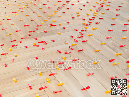 Piece of leveling and spacing plugs on tile floor installation stage