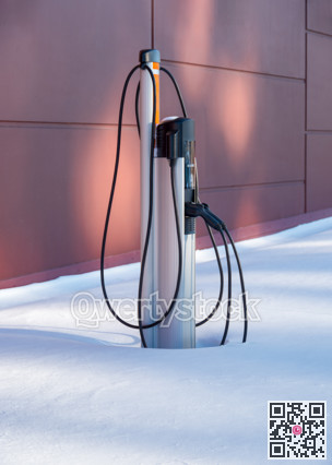EV charging station for zero emission cars in white snow pile