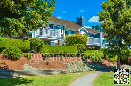 Beautiful attached houses on blue sky background in British Columbia, Canada.