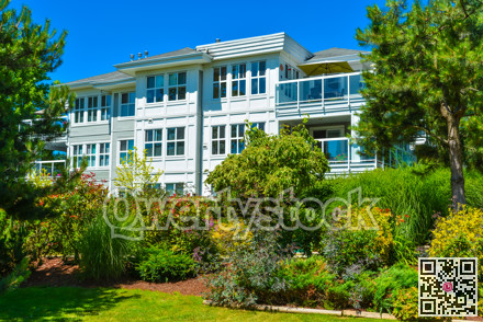 Luxury apartment building with green lawn in front