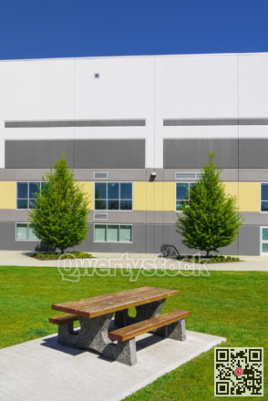 Recreation area with picnic tables on green lawn in a park