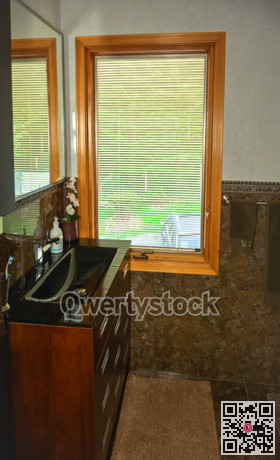 Black wash-basin at the window in a bathroom of luxury house.