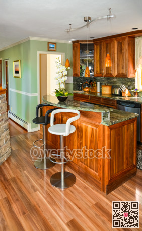 Stylish kitchen wooden interior with island table and two chairs in front.