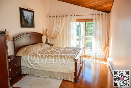 Beautiful bedroom with sun light coming through glass door.