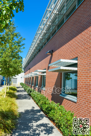 Brick wall of office building with weather shields above the windows