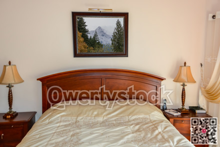 Beautiful bedroom with table lights on bedside tables beside the bed.