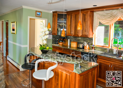 Stylish kitchen wooden interior with island table with two chairs beside.
