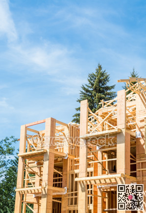 Fragment of new building under construction on blue sky background