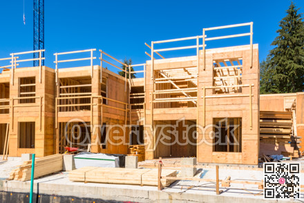 Low rise wooden framework of the building on concrete base