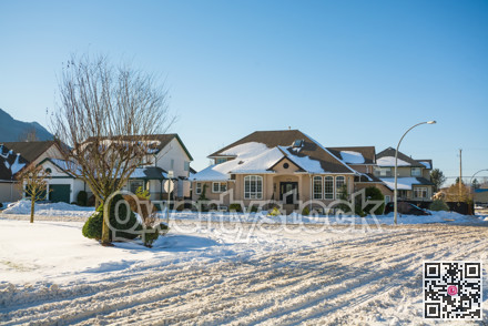 Street of residential houses in snow on winter season in suburb in Canada