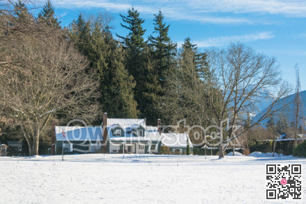 Big farmers house with spacious front yard on sunny winter day in Canada