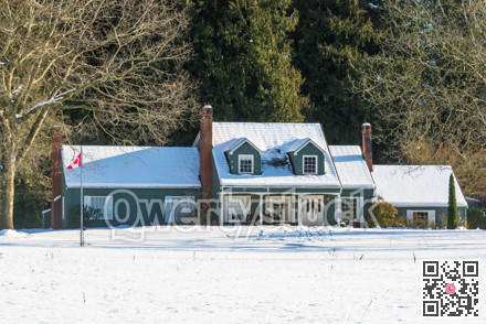 Big farmers house with spacious front yard on sunny winter day in Canada