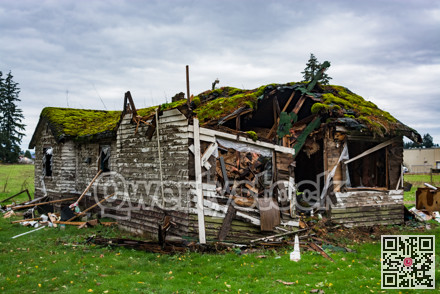 Ruins of abandoned house on cold fall day before final demolition.
