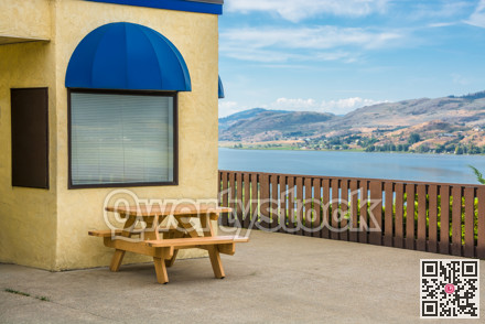 Cafe area with wooden table on Okanagan lake shore